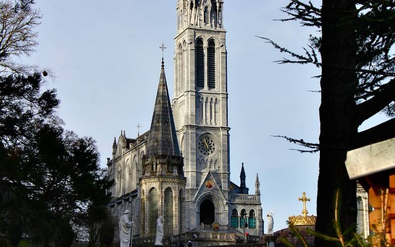 A large cathedral towering over a lush green park