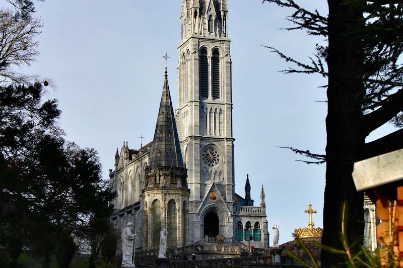 A large cathedral towering over a lush green park